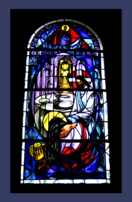 stained glass window depicting a sinner washing the feet of Jesus
